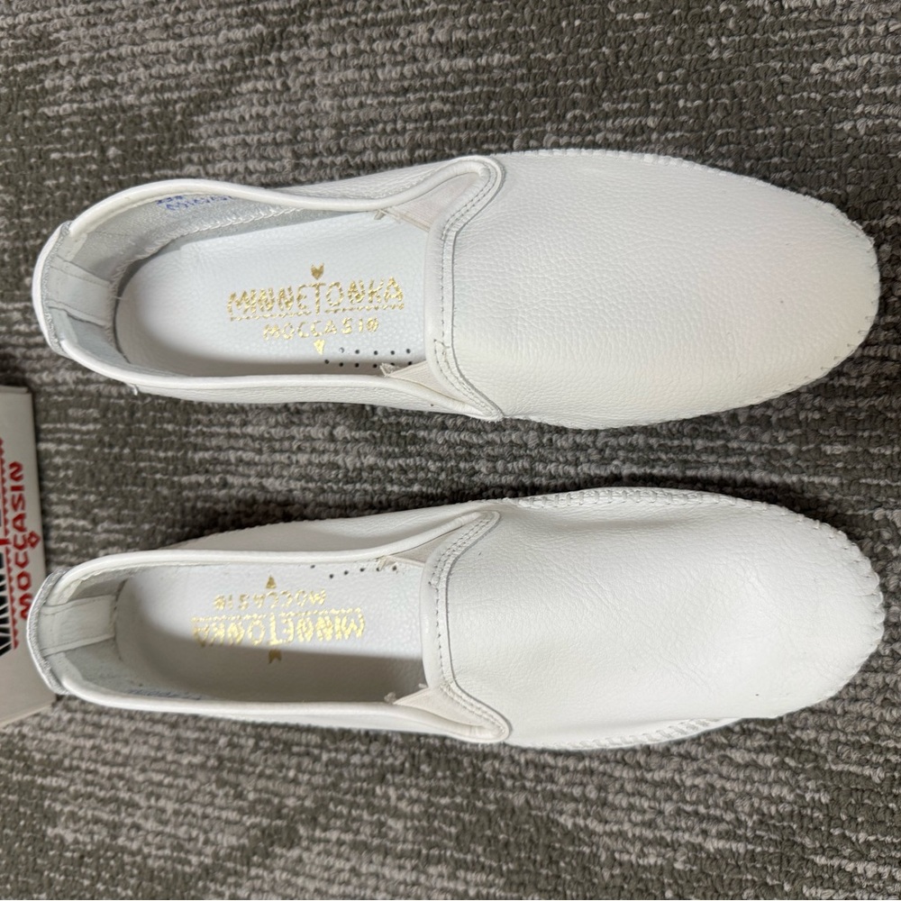 Women’s white  leather loafers by Minnetonka moccasin